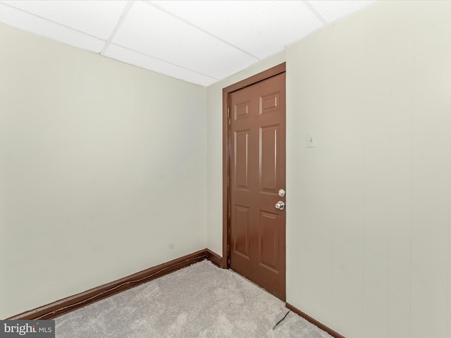 unfurnished room featuring a drop ceiling and carpet floors