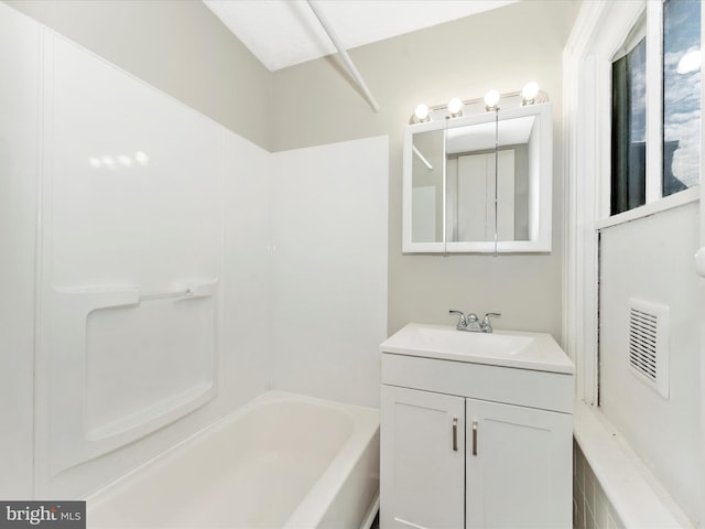 bathroom with washtub / shower combination and vanity