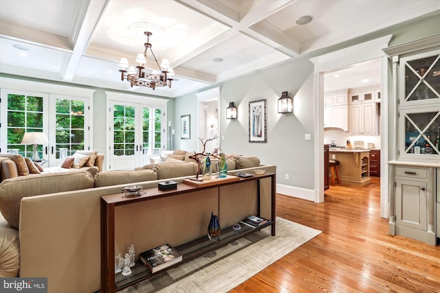 living room with french doors, coffered ceiling, light hardwood / wood-style floors, and beam ceiling