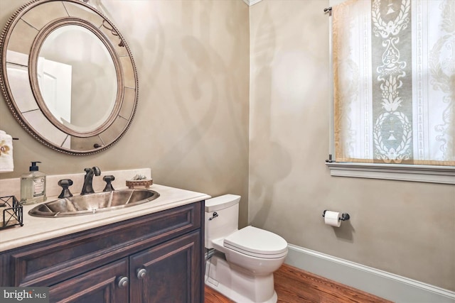 bathroom with vanity, hardwood / wood-style floors, and toilet