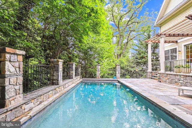 view of pool with a patio area and a pergola