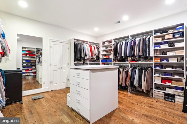 spacious closet with light hardwood / wood-style floors