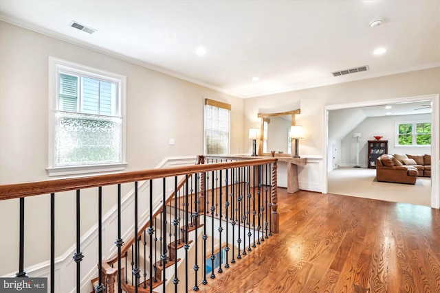 corridor with hardwood / wood-style flooring and crown molding