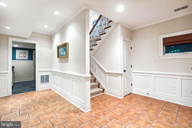 stairway featuring ornamental molding