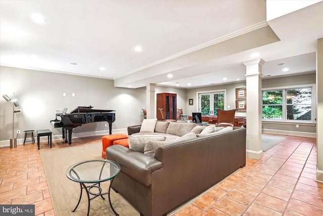 living room featuring light tile patterned flooring, ornamental molding, and ornate columns