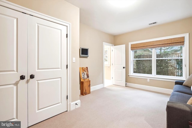 living area with light colored carpet