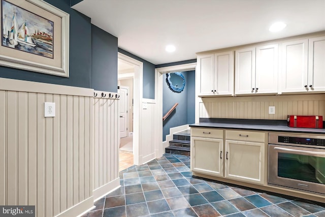 kitchen featuring cream cabinets and oven