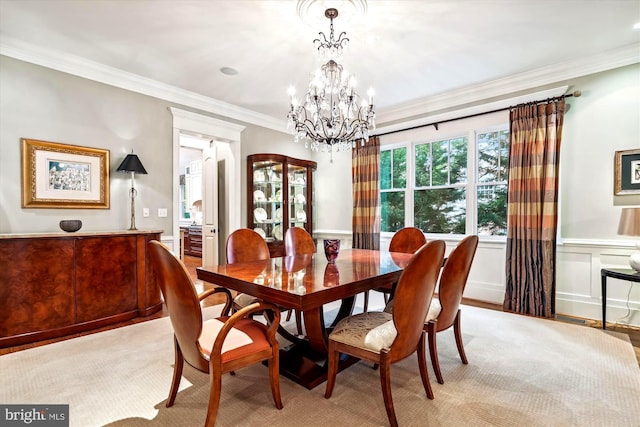 dining area featuring ornamental molding and a notable chandelier