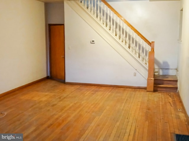 unfurnished living room with hardwood / wood-style flooring