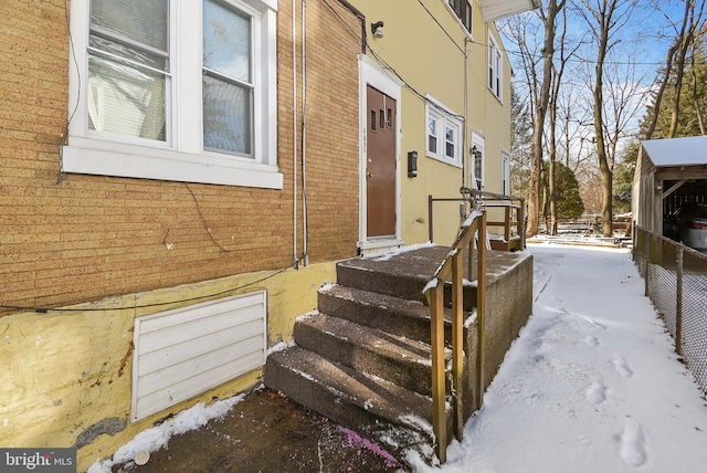 view of snow covered property entrance