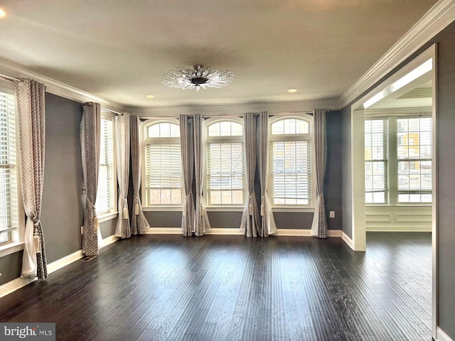 empty room featuring ornamental molding and dark hardwood / wood-style flooring