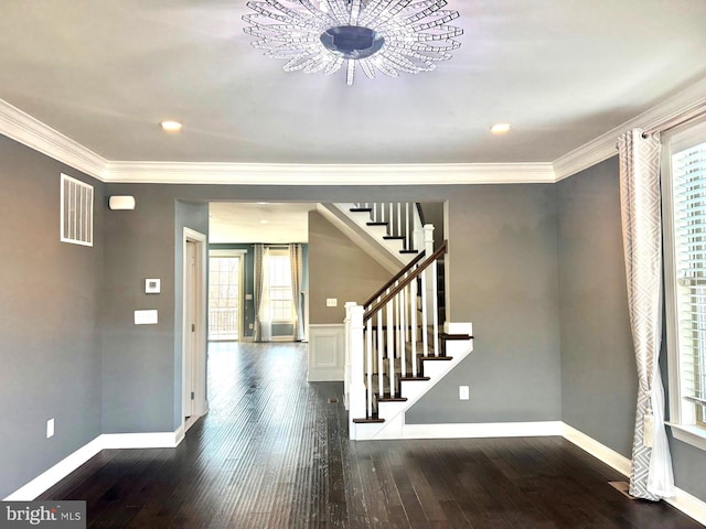 entryway with hardwood / wood-style flooring and ornamental molding