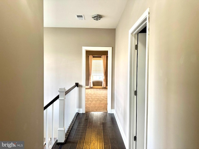 corridor with dark hardwood / wood-style flooring