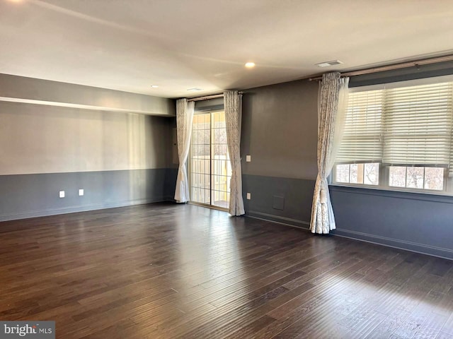 spare room with dark hardwood / wood-style flooring