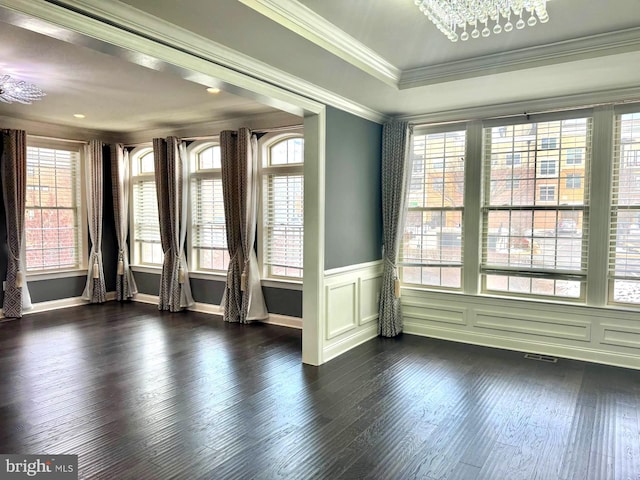 empty room with dark hardwood / wood-style flooring and ornamental molding