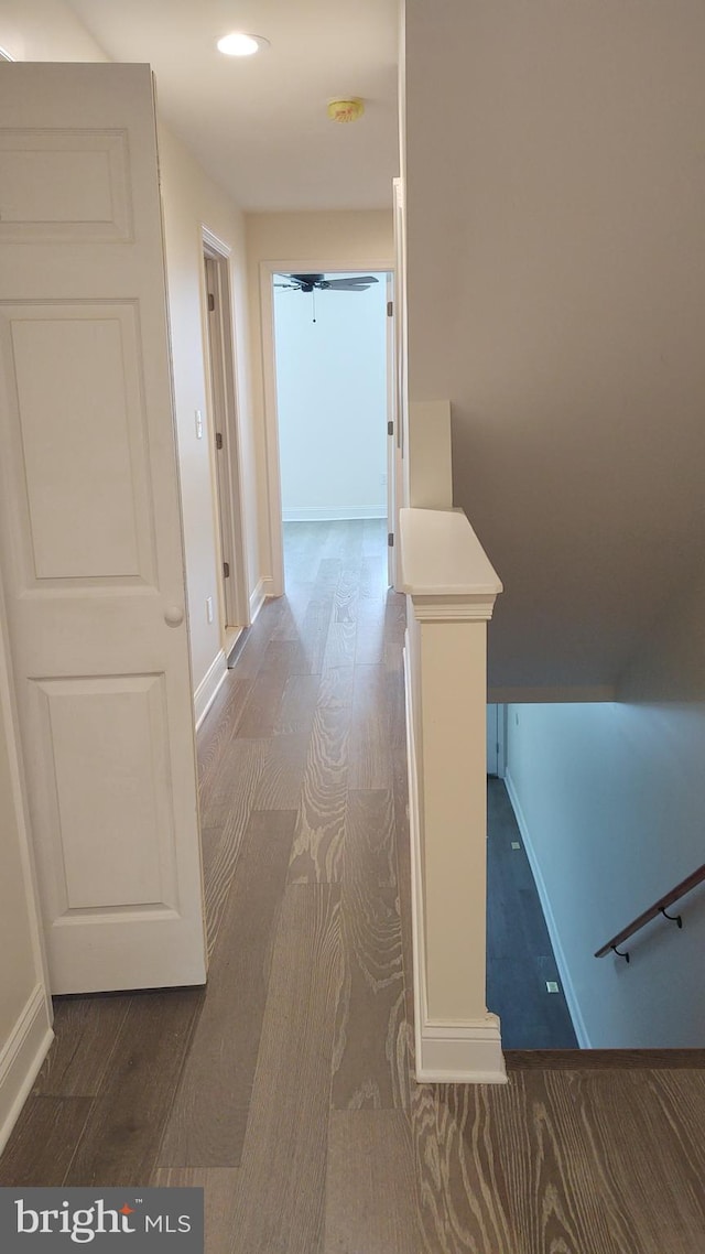 hallway with hardwood / wood-style flooring