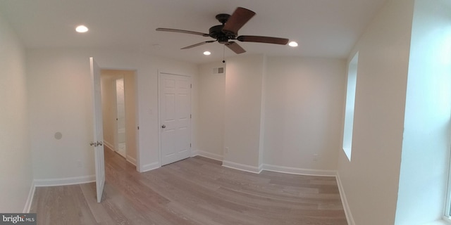 spare room featuring light hardwood / wood-style floors and ceiling fan