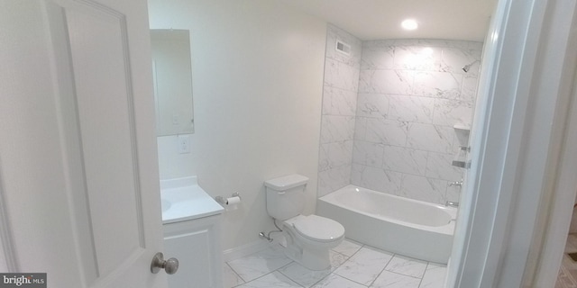 full bathroom featuring tiled shower / bath, vanity, and toilet