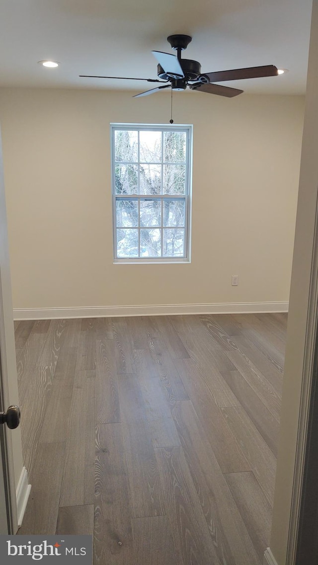 unfurnished room featuring hardwood / wood-style flooring and ceiling fan