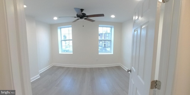 spare room with wood-type flooring and ceiling fan