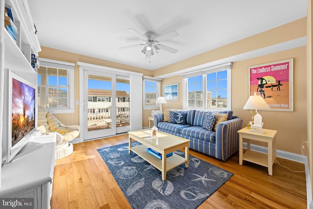 living room with hardwood / wood-style flooring and ceiling fan