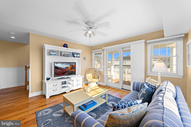 living room with light hardwood / wood-style floors and ceiling fan