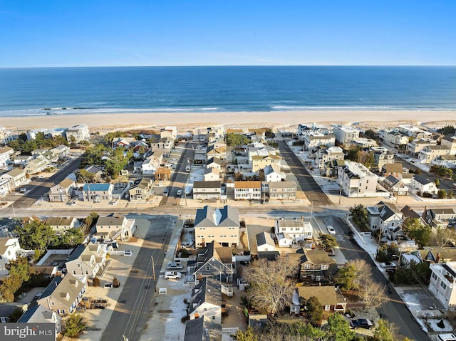 drone / aerial view featuring a view of the beach and a water view