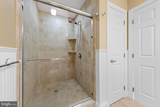 bathroom featuring a shower with shower door