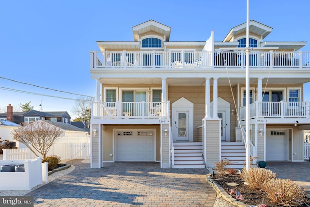 view of front of property with a garage and a balcony