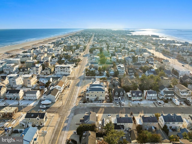 bird's eye view featuring a water view and a beach view