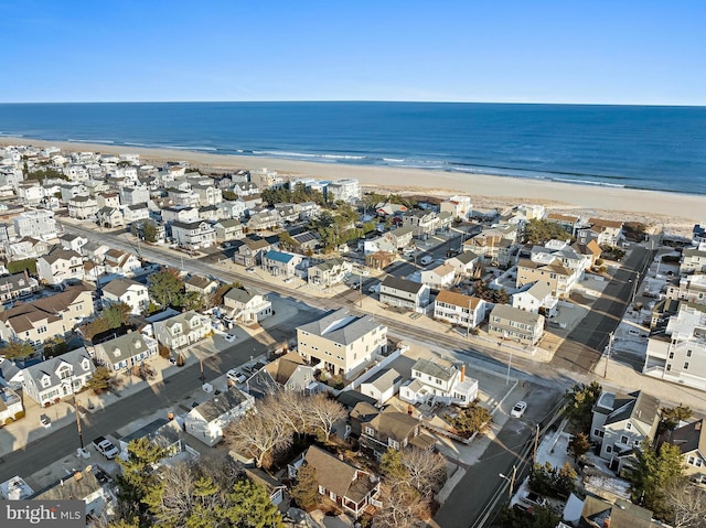 drone / aerial view featuring a view of the beach and a water view