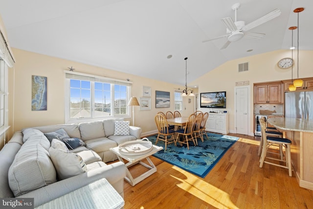 living room with wine cooler, ceiling fan, high vaulted ceiling, and light wood-type flooring