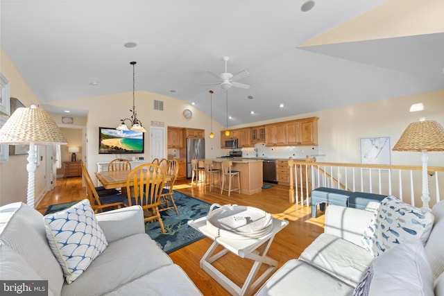 living room featuring ceiling fan, high vaulted ceiling, and light wood-type flooring