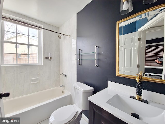 full bathroom featuring tiled shower / bath, vanity, and toilet