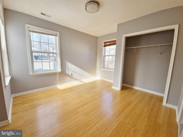 unfurnished bedroom with light hardwood / wood-style floors and a closet