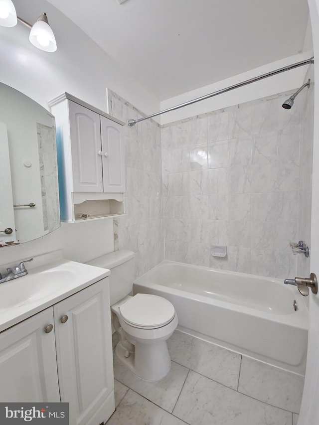 full bathroom with tiled shower / bath, vanity, tile patterned floors, and toilet