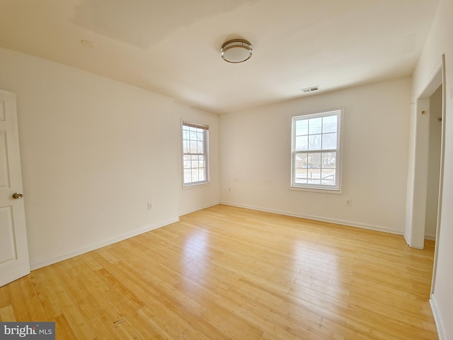 unfurnished room with plenty of natural light and light wood-type flooring