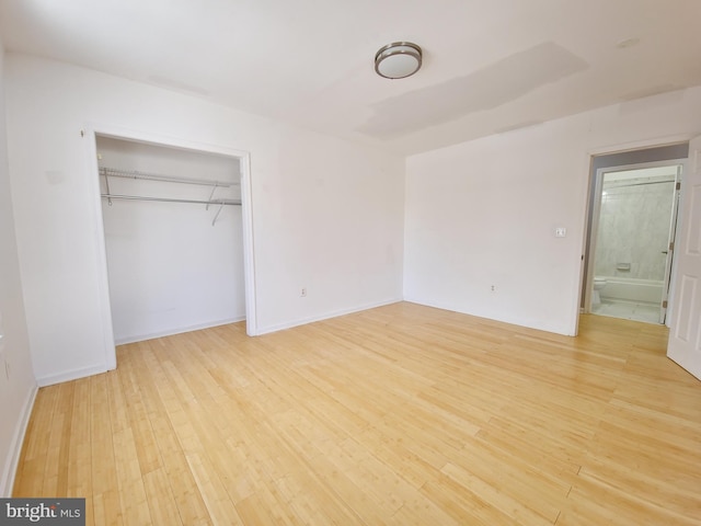 unfurnished bedroom featuring light hardwood / wood-style floors and a closet