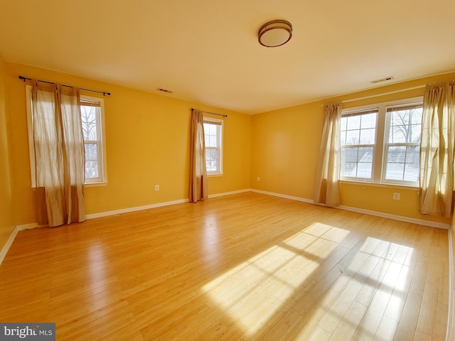 unfurnished room featuring hardwood / wood-style floors