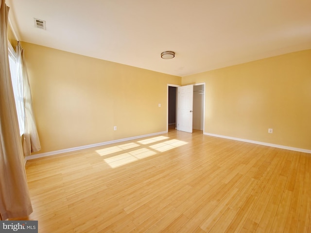 spare room featuring light hardwood / wood-style floors