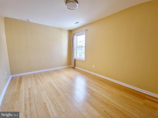 unfurnished room with light hardwood / wood-style flooring