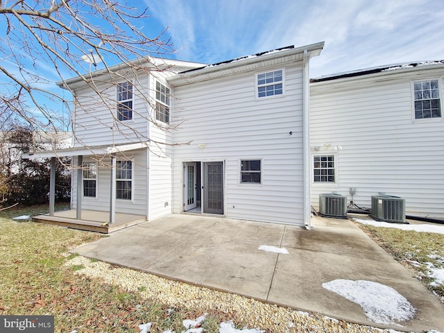 rear view of house with cooling unit and a patio area