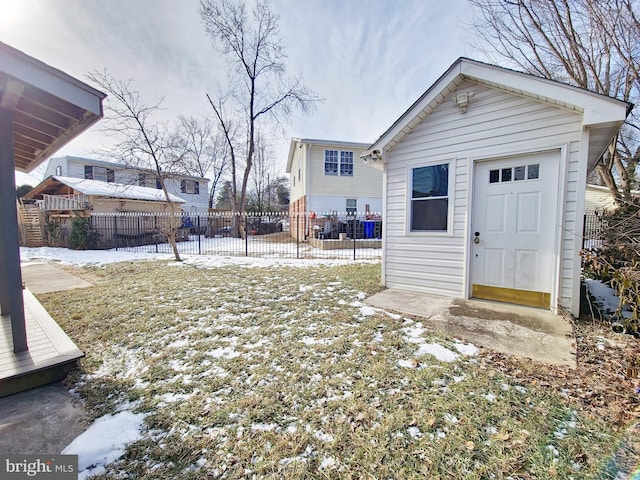 yard covered in snow with an outbuilding