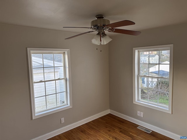 unfurnished room featuring ceiling fan and dark hardwood / wood-style flooring