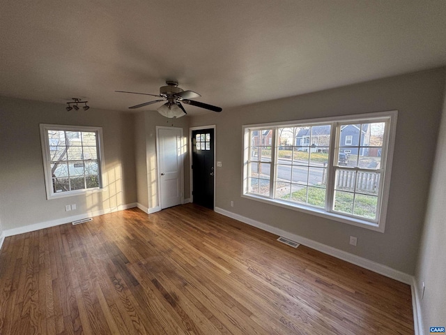 interior space featuring wood-type flooring and ceiling fan