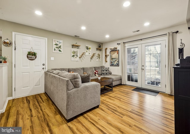 living room with hardwood / wood-style floors and french doors