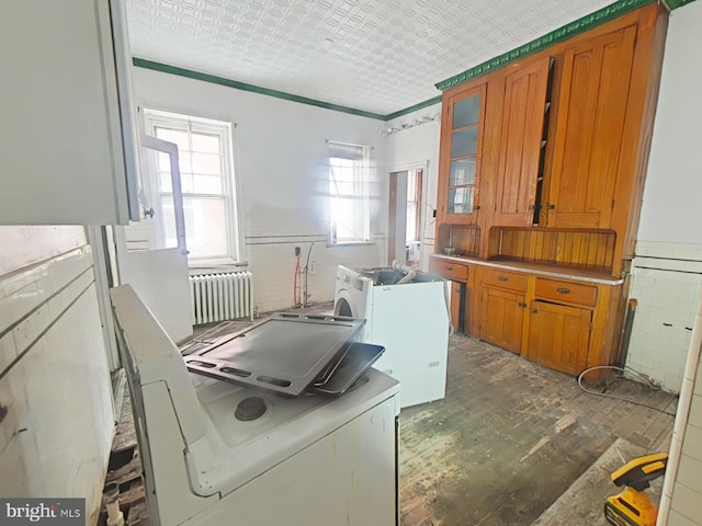 laundry room featuring washer / clothes dryer and radiator