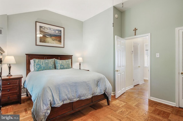 bedroom featuring parquet flooring and lofted ceiling