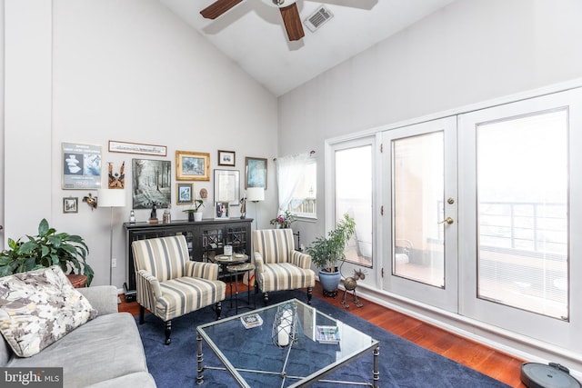 living room with ceiling fan, dark hardwood / wood-style floors, high vaulted ceiling, and french doors