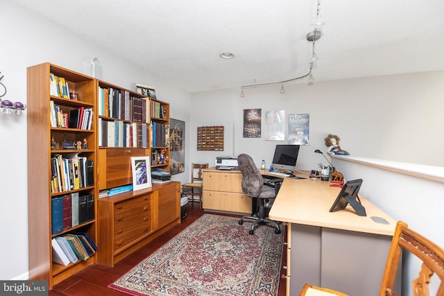 office area featuring rail lighting, dark hardwood / wood-style flooring, and a textured ceiling